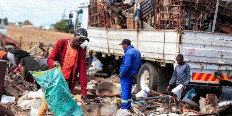 Scrap-metal dealers sorting metal scrap at a scrapyard