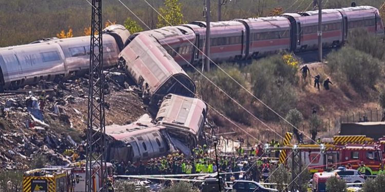 Derailed high-speed train carriages and emergency responders at the scene of a fatal collision near Urda, Toledo, Spain.