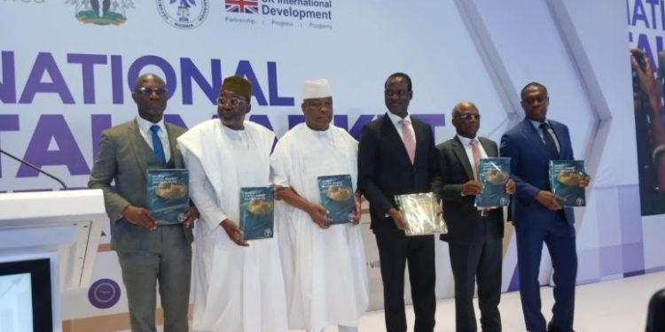 Minister of Finance and Coordinating Minister of the Economy Taiwo Oyedele and representatives of the Securities and Exchange Commission and UK International Development—holding copies of the newly launched roadmap.