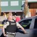 Local police officers stand beside their vehicles outside Silver Rail Elementary School following a deadly shooting in Oregon. (photo credit: BBC News)