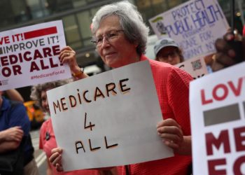 People participate in a rally marking the 61st anniversary of Medicare and Medicaid across from Bellevue Hospital in New York City (Photo credit - reuters.com)