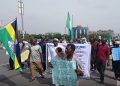 Retired Nigerian police officers hold a banner during a protest over the contributory pension scheme.