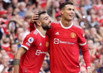 Manchester United midfielder Bruno Fernandes alongside Cristiano Ronaldo during a team match, as Fernandes backs the veteran forward amid uncertainty over his international future.