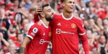 Manchester United midfielder Bruno Fernandes alongside Cristiano Ronaldo during a team match, as Fernandes backs the veteran forward amid uncertainty over his international future.